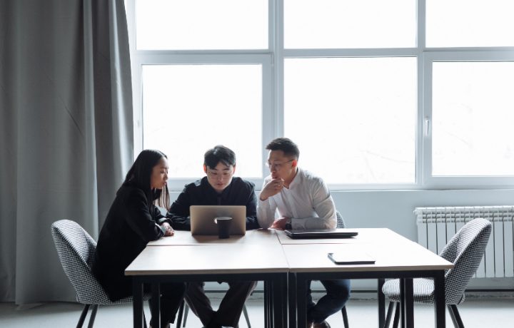 Nhóm agency SEO làm việc cùng laptop trong phòng họp