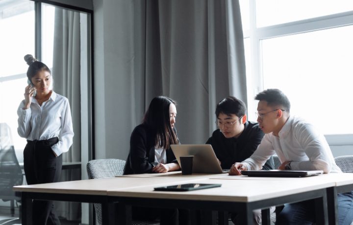 Đội marketing trao đổi kế hoạch nội dung quanh laptop